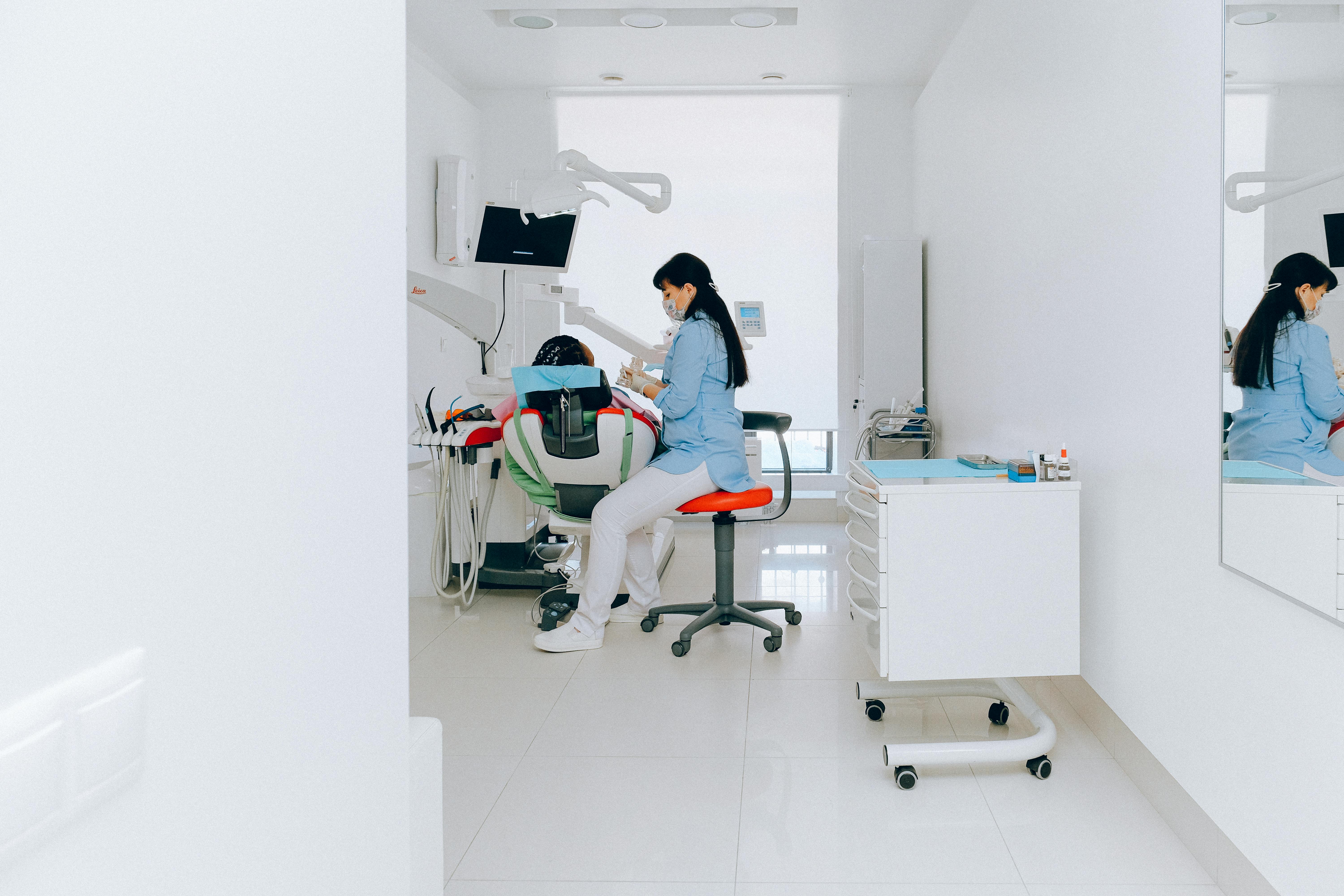 Dental professional treating a patient in a modern room