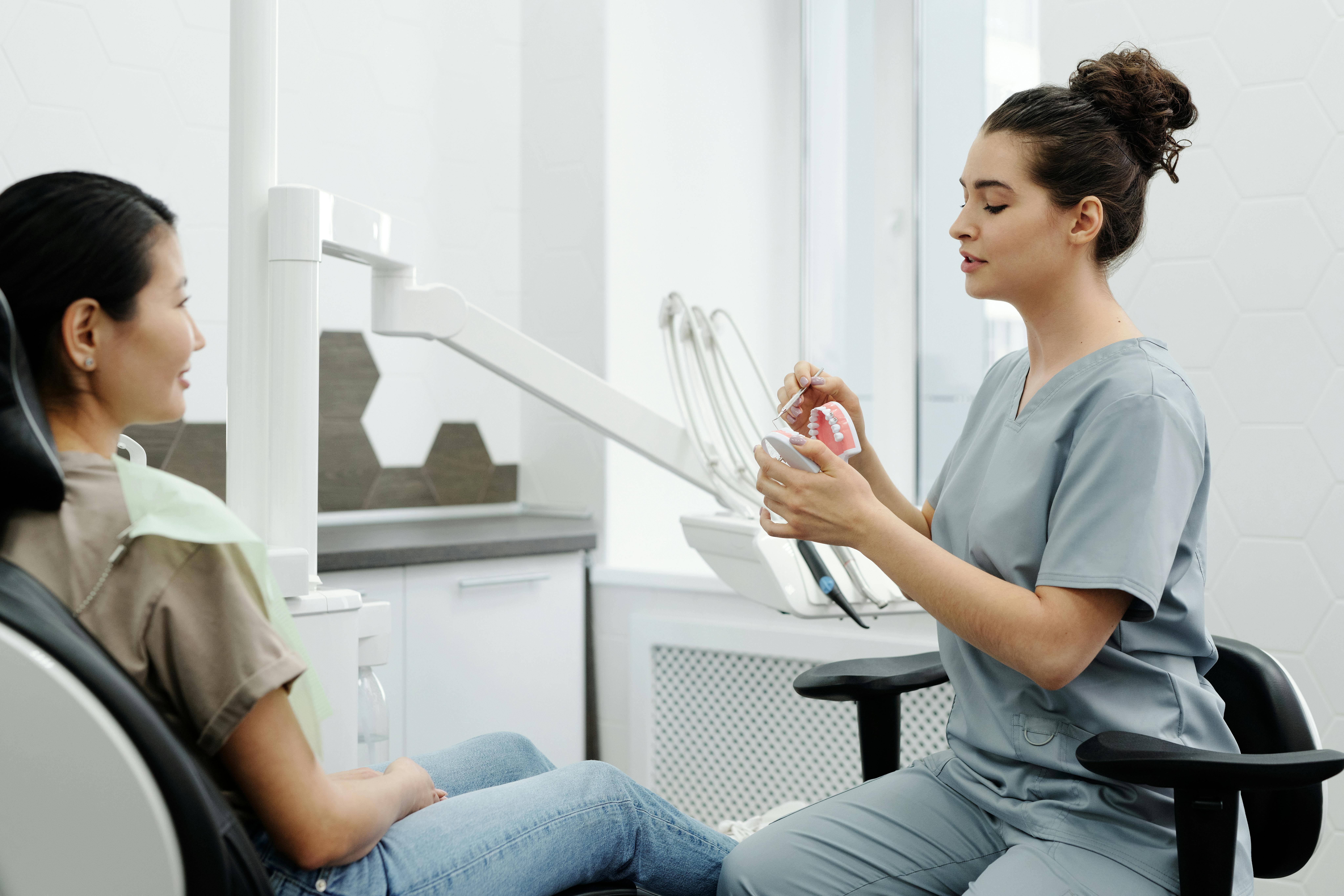 Dentist consulting with a patient in a clean modern clinic